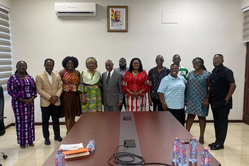 Eyram Bashan with a delegation in a boardroom.