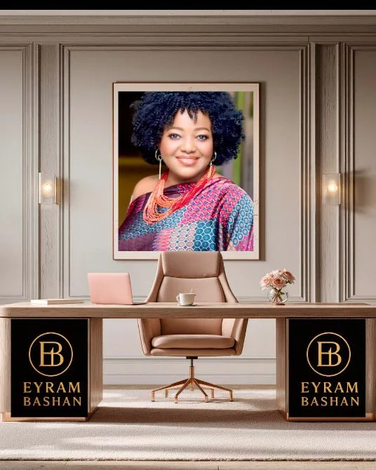 Eyram Bashan brand artwork: a monogrammed desk beneath a framed portrait.