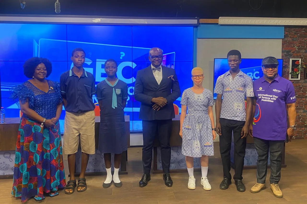 Eyram Bashan with participants at a television studio for an International Day of Persons with Disabilities broadcast.